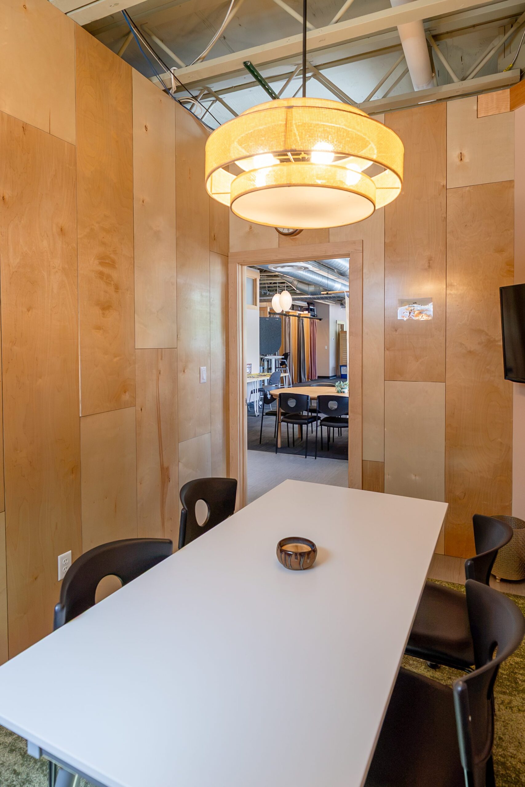 Meeting room with pendant light and white table